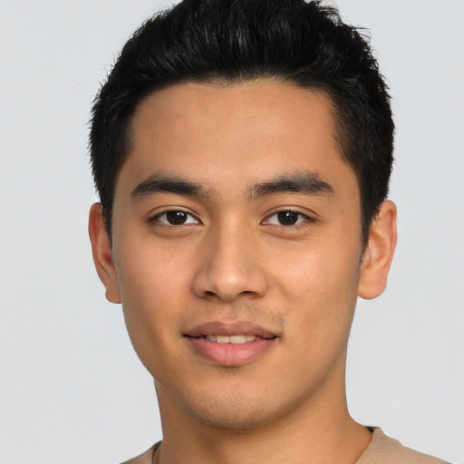Joyful asian young-adult male with short  black hair and brown eyes