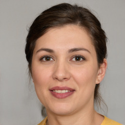 Joyful white young-adult female with medium  brown hair and brown eyes