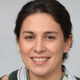 Joyful white adult female with medium  brown hair and brown eyes