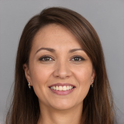 Joyful white young-adult female with long  brown hair and grey eyes