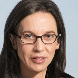 Joyful white adult female with long  brown hair and brown eyes