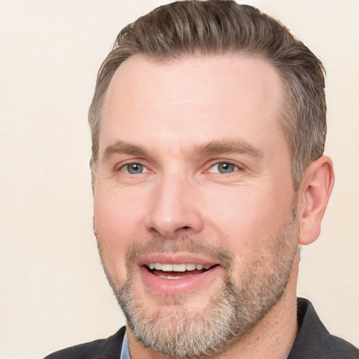 Joyful white adult male with short  brown hair and grey eyes