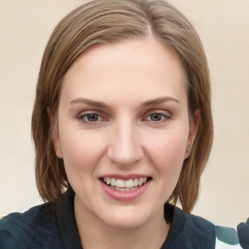 Joyful white young-adult female with medium  brown hair and grey eyes