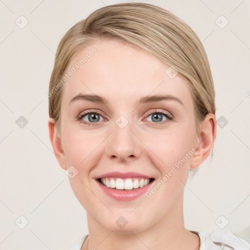 Joyful white young-adult female with medium  brown hair and blue eyes