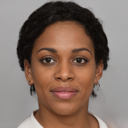 Joyful black young-adult female with short  brown hair and brown eyes