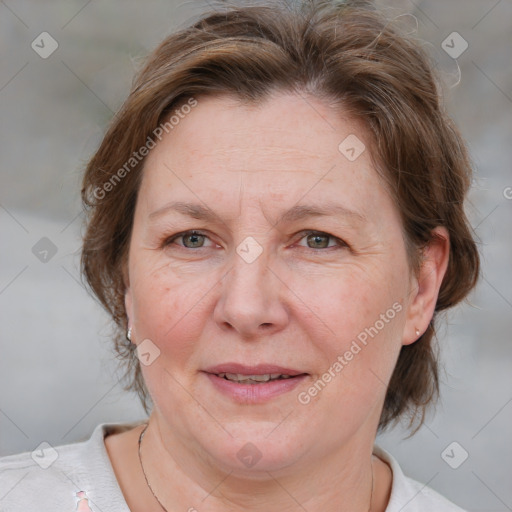 Joyful white adult female with medium  brown hair and blue eyes