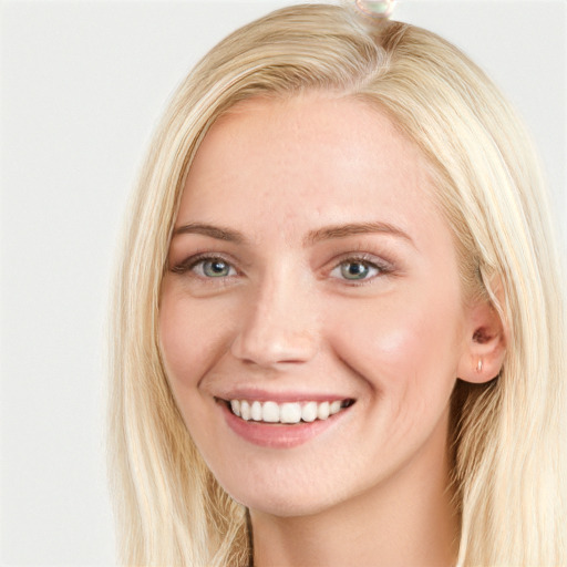 Joyful white young-adult female with long  brown hair and blue eyes