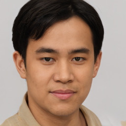 Joyful asian young-adult male with short  brown hair and brown eyes