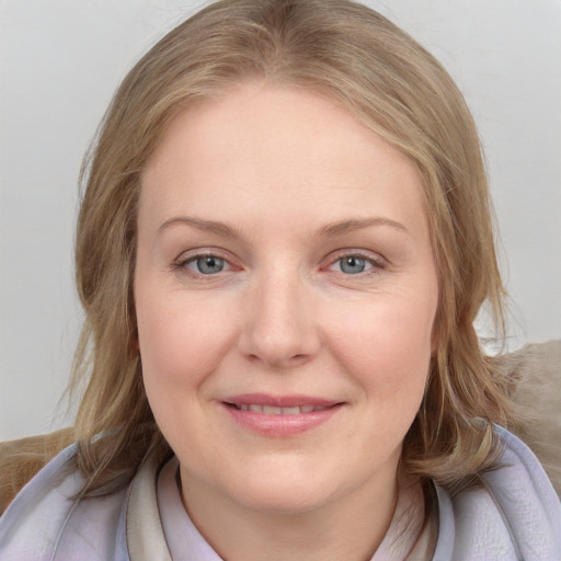 Joyful white young-adult female with medium  brown hair and blue eyes