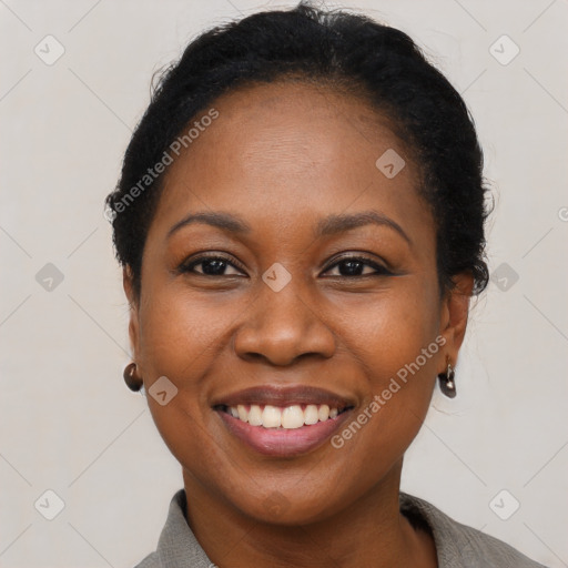 Joyful black adult female with short  brown hair and brown eyes