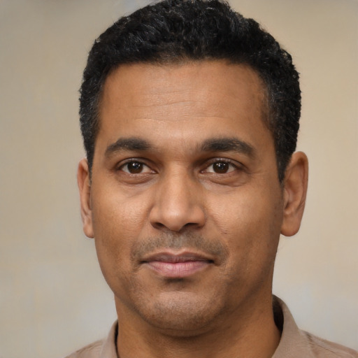 Neutral latino adult male with short  black hair and brown eyes