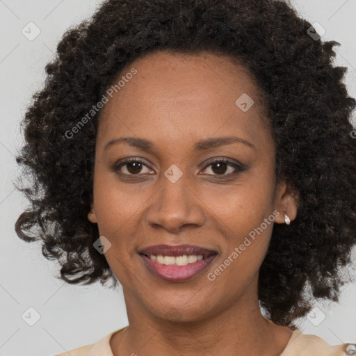 Joyful black adult female with medium  brown hair and brown eyes