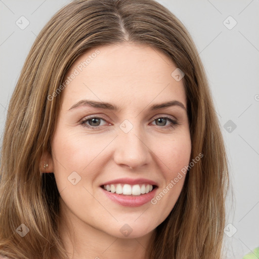 Joyful white young-adult female with long  brown hair and green eyes