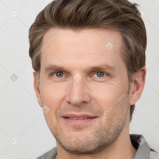 Joyful white adult male with short  brown hair and grey eyes