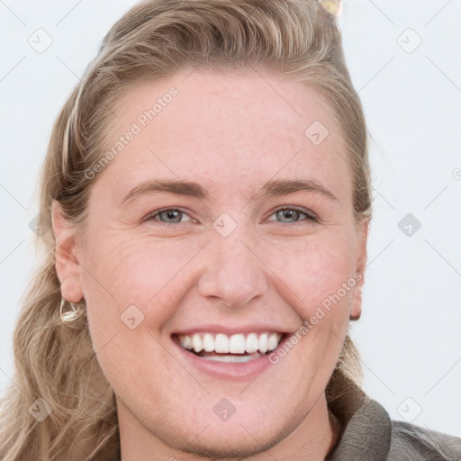 Joyful white young-adult female with long  brown hair and blue eyes