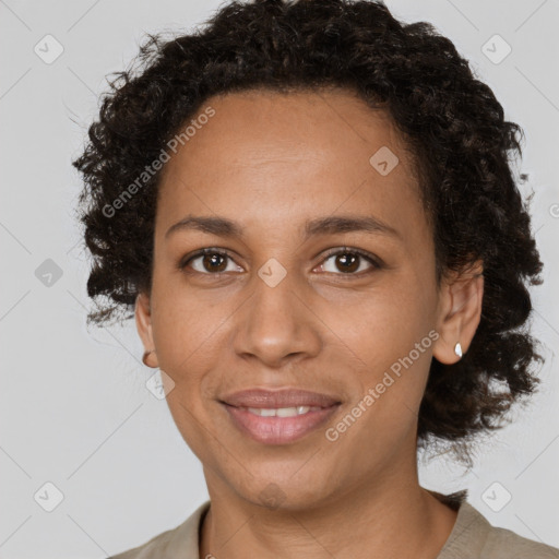 Joyful black adult female with medium  brown hair and brown eyes