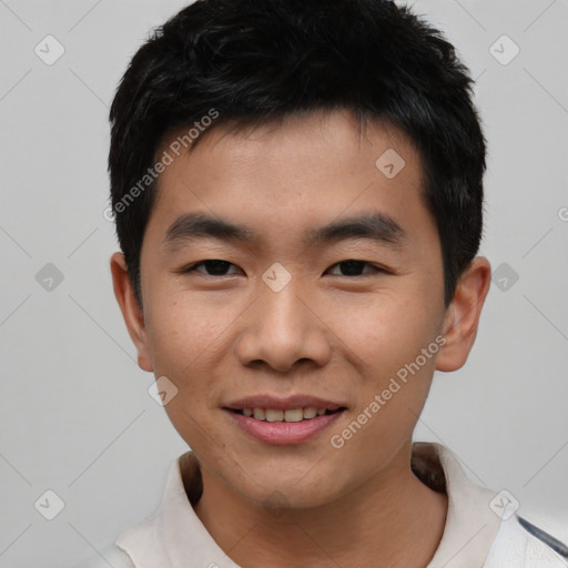 Joyful asian young-adult male with short  black hair and brown eyes