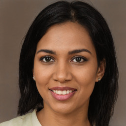 Joyful latino young-adult female with long  black hair and brown eyes