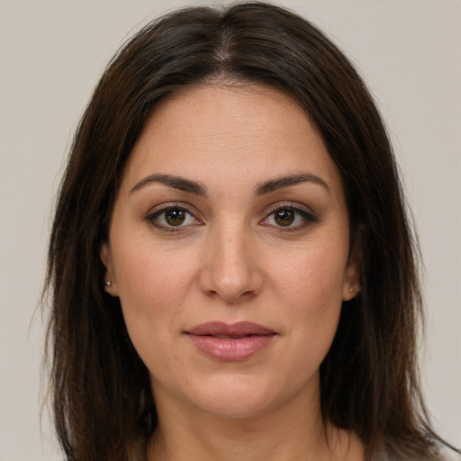 Joyful white young-adult female with long  brown hair and brown eyes
