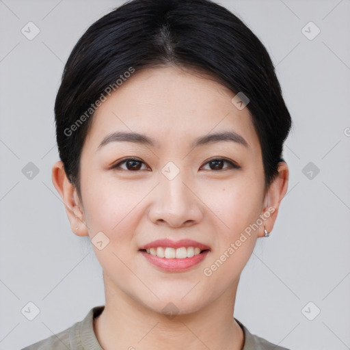 Joyful asian young-adult female with short  black hair and brown eyes