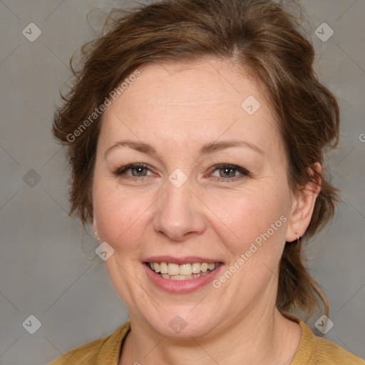 Joyful white adult female with medium  brown hair and blue eyes