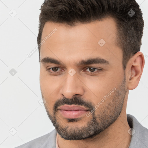 Joyful white young-adult male with short  brown hair and brown eyes