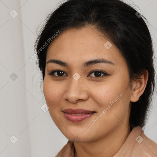 Joyful latino young-adult female with long  brown hair and brown eyes