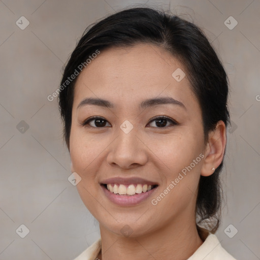 Joyful latino young-adult female with medium  brown hair and brown eyes