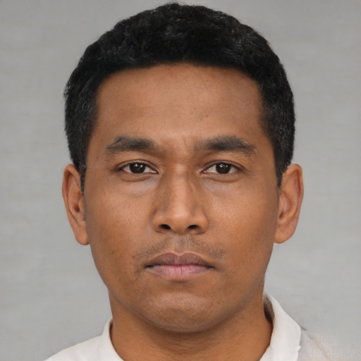 Neutral latino young-adult male with short  black hair and brown eyes