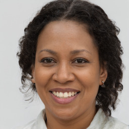 Joyful black adult female with medium  brown hair and brown eyes