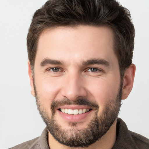 Joyful white young-adult male with short  brown hair and brown eyes