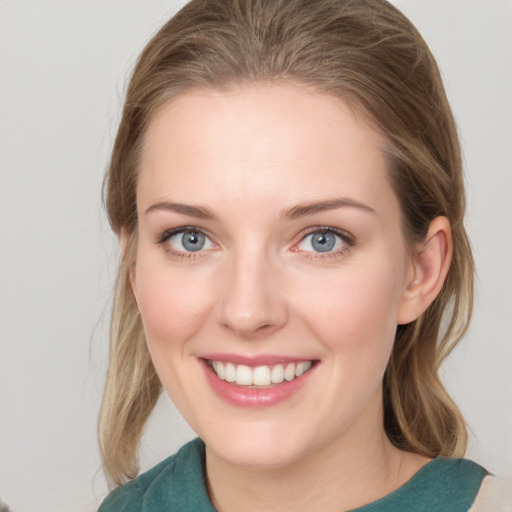 Joyful white young-adult female with medium  brown hair and green eyes