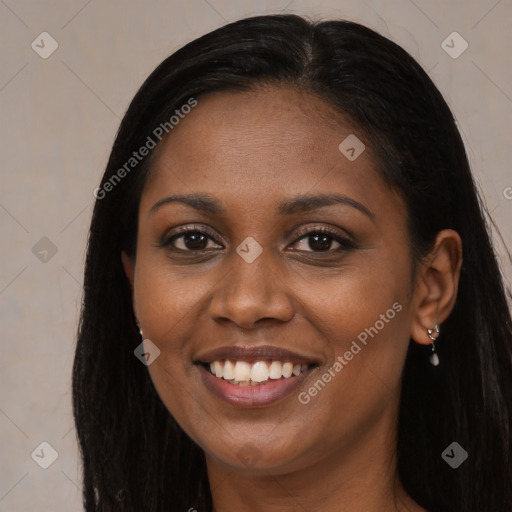 Joyful black young-adult female with long  brown hair and brown eyes