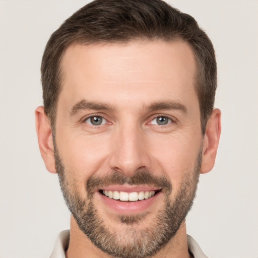 Joyful white young-adult male with short  brown hair and brown eyes