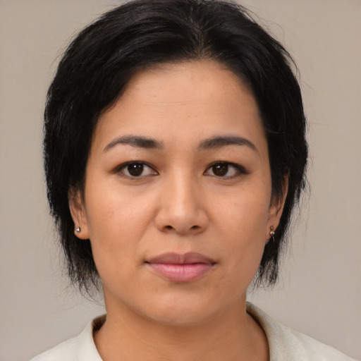Joyful asian young-adult female with medium  black hair and brown eyes