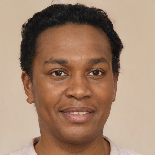 Joyful black adult male with short  brown hair and brown eyes