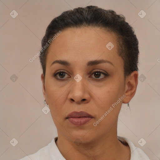 Joyful latino adult female with short  brown hair and brown eyes