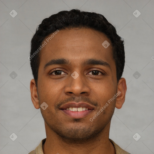 Joyful black young-adult male with short  black hair and brown eyes