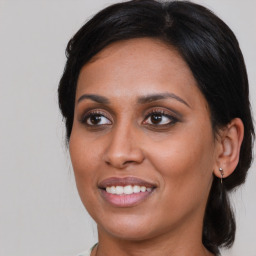 Joyful asian young-adult female with medium  brown hair and brown eyes