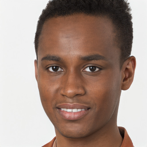 Joyful black young-adult male with short  brown hair and brown eyes