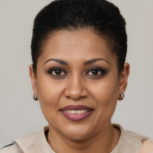 Joyful black adult female with short  brown hair and brown eyes