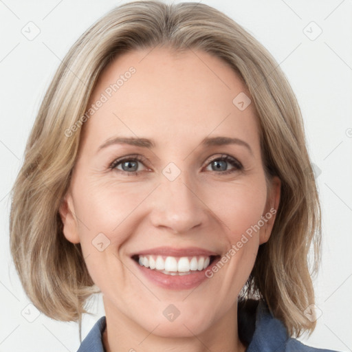 Joyful white young-adult female with medium  brown hair and blue eyes