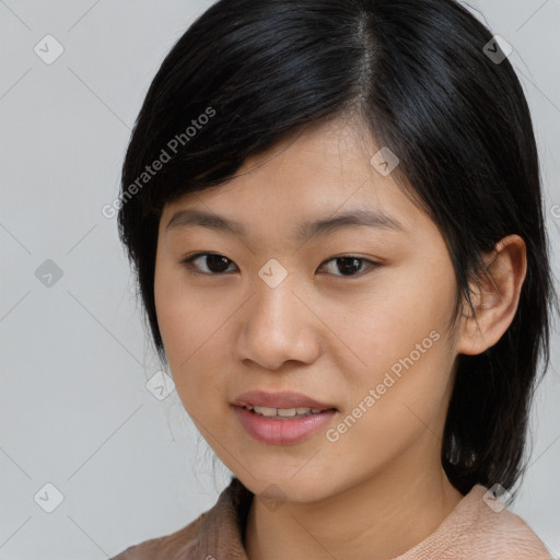 Joyful asian young-adult female with medium  black hair and brown eyes