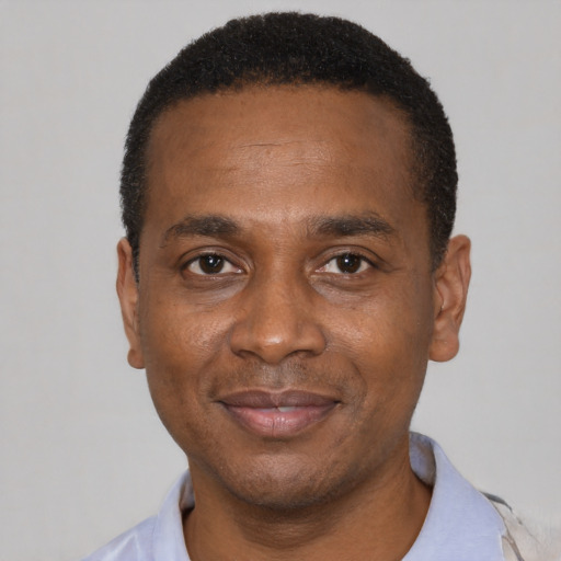 Joyful latino adult male with short  black hair and brown eyes