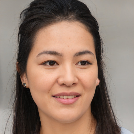 Joyful white young-adult female with long  brown hair and brown eyes
