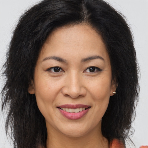 Joyful white adult female with long  brown hair and brown eyes