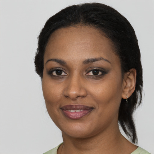 Joyful black young-adult female with medium  black hair and brown eyes