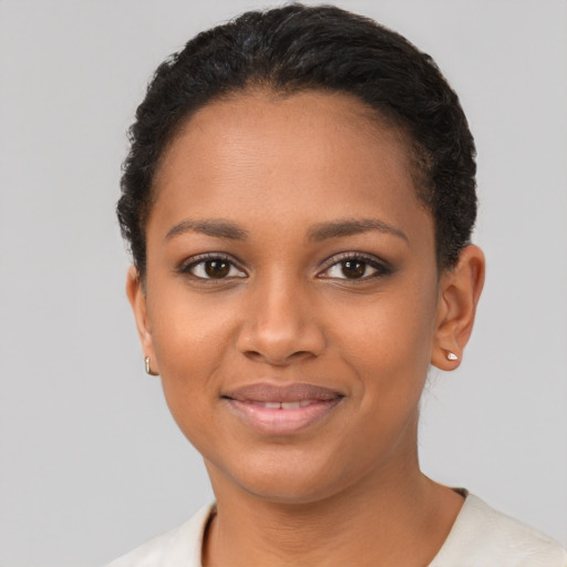 Joyful black young-adult female with short  brown hair and brown eyes