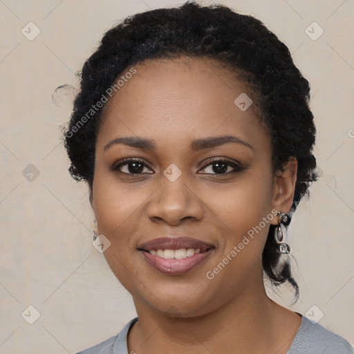 Joyful black young-adult female with long  black hair and brown eyes