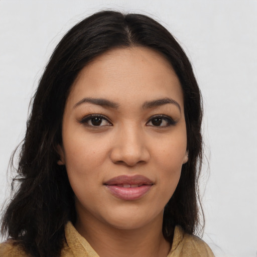 Joyful latino young-adult female with long  brown hair and brown eyes
